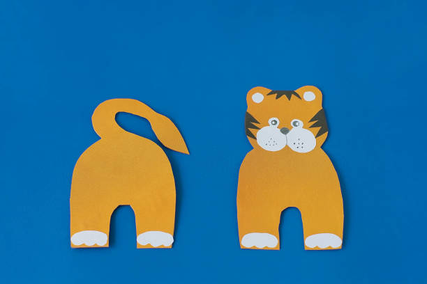 istock Step 5. Step by step instructions on how to make a tiger at home. Craft for New Year 2022. Take colored paper. A simple creative idea with your own hands. DIY children's art project 1322956464