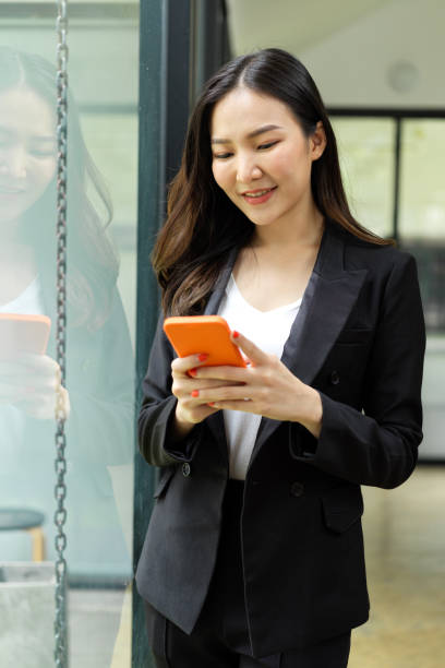 istock Businesswoman using smartphone while relaxing in office building 1322962026