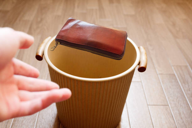 istock Throw a used wallet into the trash 1322962816