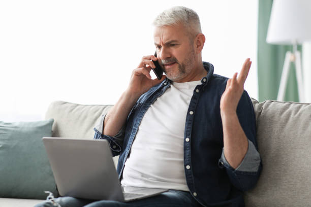 istock Angry mature man having phone fight with Internet provider 1322963767