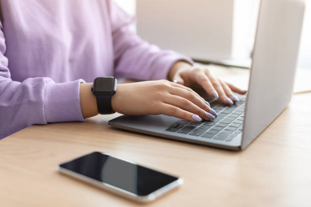istock Happy woman sitting at desk reading text message 1322963854