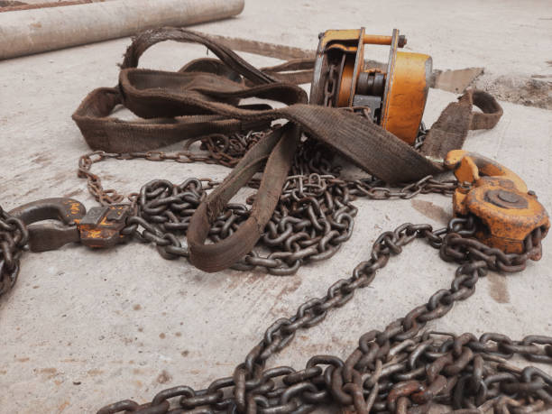 istock orange hook with sling belt and chain block or chain hoist which is placed on a cement floor, usually used for lifting in factories, with a maximum load specification of 2 tons 1322964562