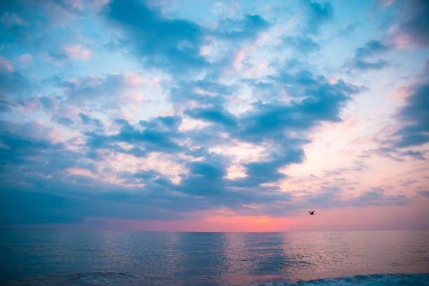 istock beautiful sunset with clouds over the sea 1322964620