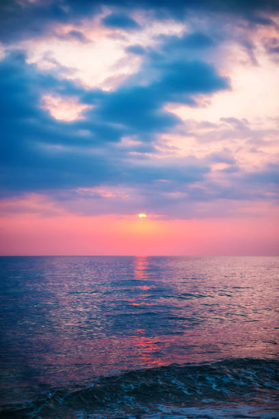istock beautiful sunset with clouds over the sea 1322964639