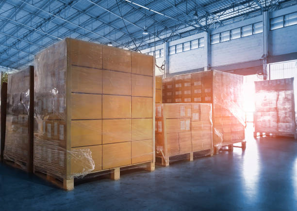 istock Stacked of Package Boxes Wrapped Plastic Flim on Pallets at Storage Warehouse. Shipment Boxes. Cargo Export- Import. Shipping Warehouse Logistics. 1322965567