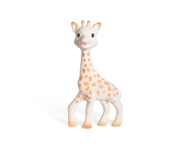 Photo of baby Giraffe doll isolated on white background with shadow reflection