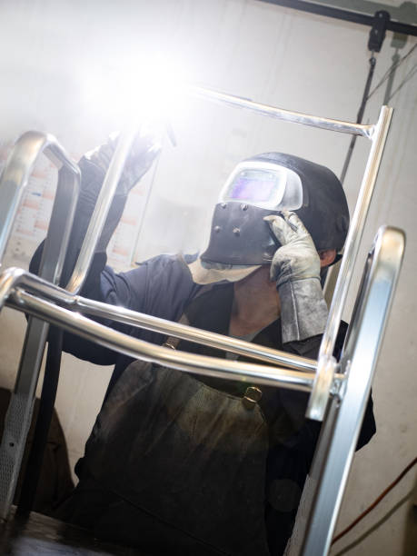 istock Welder erecting technical steel in a manufacturing factory. 1322968383