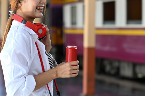 Cropped shot of asian woman traveler standing in train station.