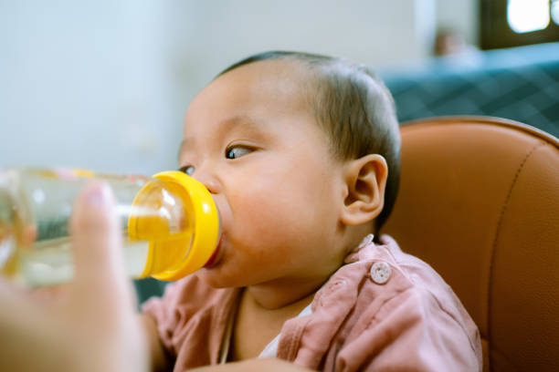 istock Asian Baby Drinking Water . 1322969266