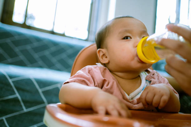 istock Asian Baby Drinking Water . 1322969267