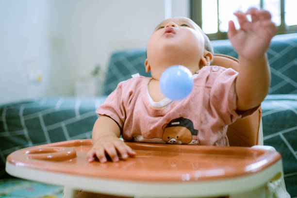 istock Happy Baby Boy Playing With ball. 1322969280