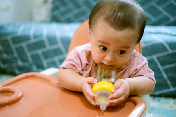 istock Asian Baby Drinking Water . 1322969291