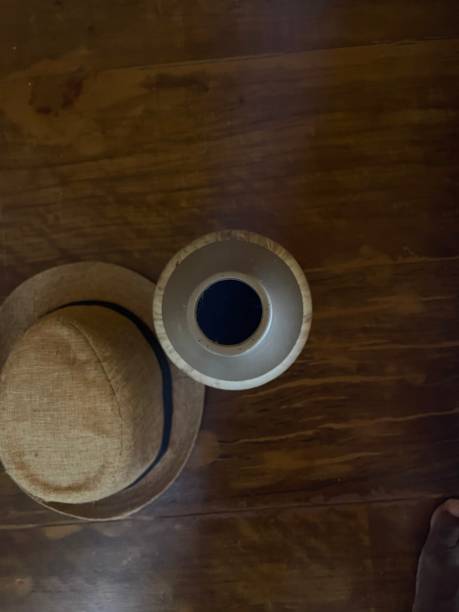 istock Hat and flower pot on the wooden surface 1322969892