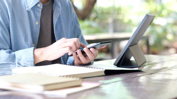 istock Online study, Man hand using mobile phone for digital home study class, Adult male student doing lesson while e learning by smartphone , Education 1322971236