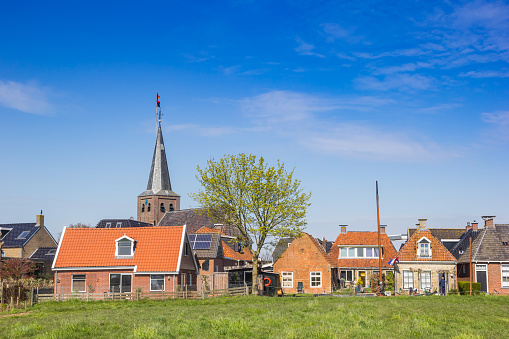 Old houses and church tower in Warten, Netherlands