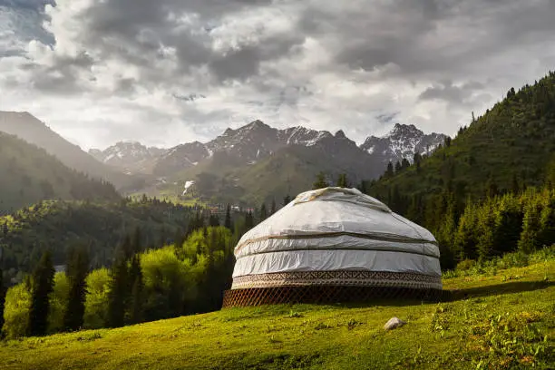 Guest house complex of white Yurt nomadic house at green mountain valley in Almaty, Kazakhstan