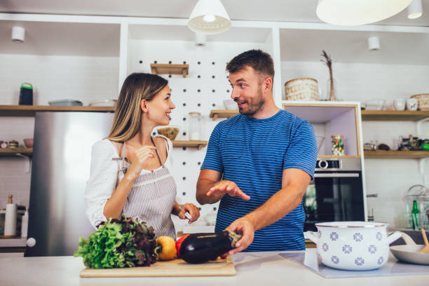 istock Happy loving couple is preparing the proper meal in the kitchen. 1322973292