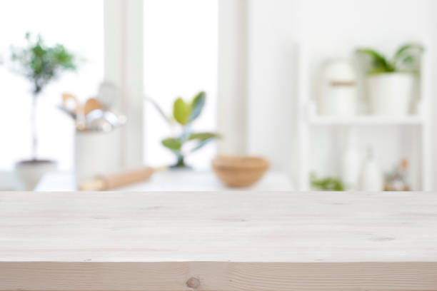 istock Wooden texture table on blurred kitchen window sill and shelf 1322973528