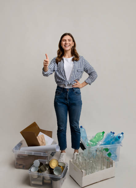 istock Sustainability Concept. Woman Standing Next To Containers With Different Materials For Recycling 1322974295