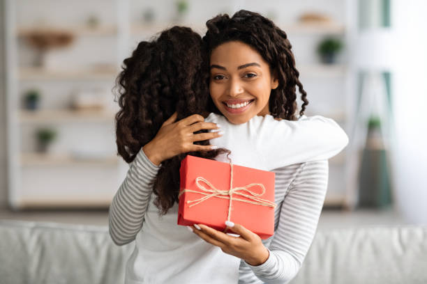 istock Curly black girl greeting her mom with birthday 1322975491