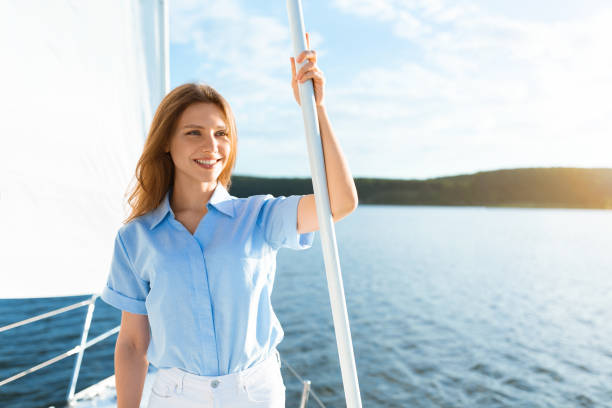 istock Lady Sailing On Sailboat Standing On Deck Enjoying Yacht Ride 1322975636