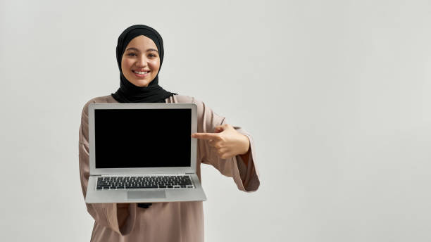 istock Happy young arabian woman demonstrating laptop screen 1322975700