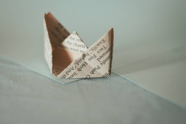 istock Paper boat made from old newspaper 1322975704