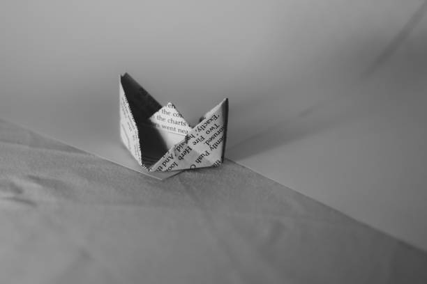 istock A paper boat made from newspaper in black and white 1322975711