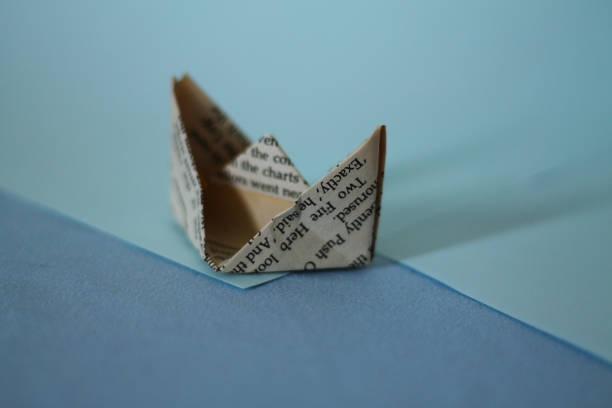 istock Paper boat made from old newspaper 1322975728