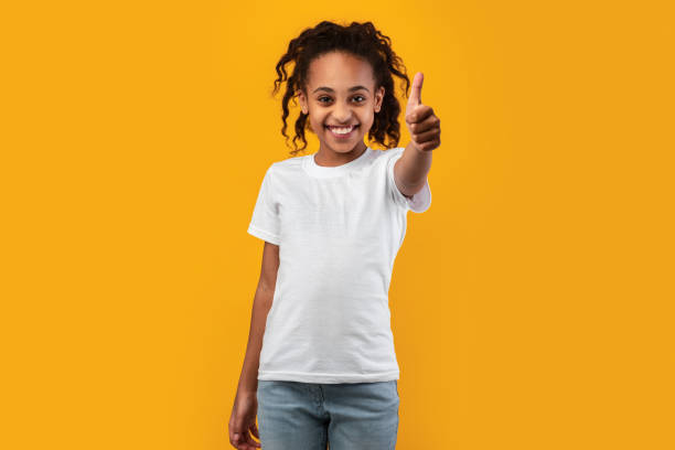 istock Happy black girl gesturing thumb up and smiling 1322976448