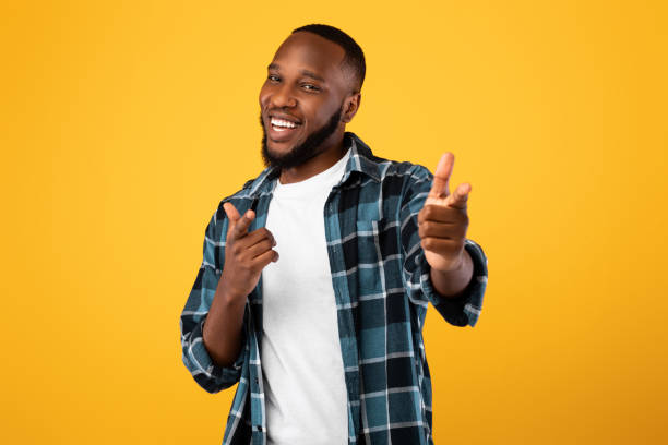 istock Positive Black Bearded Guy Pointing Fingers At Camera, Yellow Background 1322976832