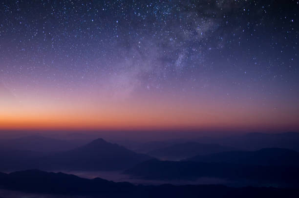 istock Milky way is visible in the dark night sky. Beautiful starry background with galaxy nebula and beautiful view of foggy landscape on top of mountain at the morning. 1322977191