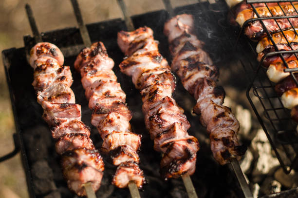 istock Making barbecue shashlik on wooden coal grill 1322977987