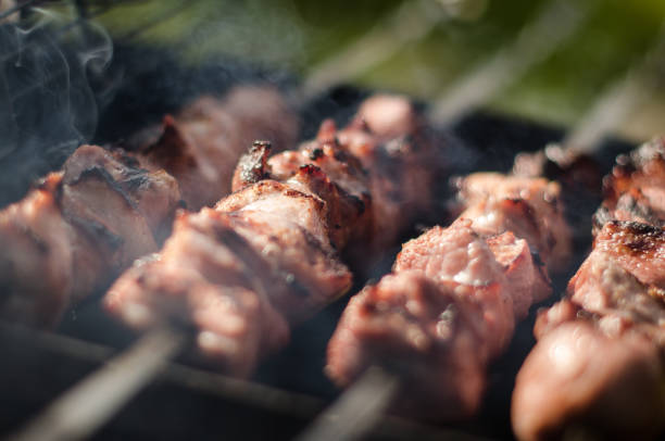 istock Making barbecue shashlik on wooden coal grill 1322978018