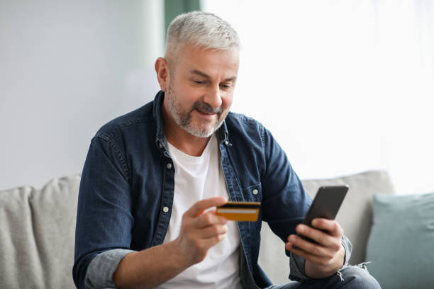 istock Happy senior man paying for goods and services online 1322978276