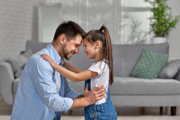 istock father hugging his cute little child daughter. 1322979234