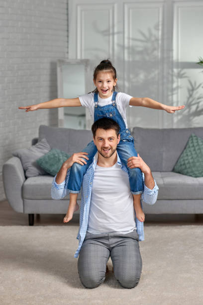 istock happy dad holds her cute child daughter on shoulders 1322979436