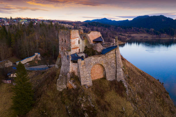 Scenic view of ruins of ancient fortified Czorsztyn Castle on top of hill above lake in Polish city of Niedzica in spring