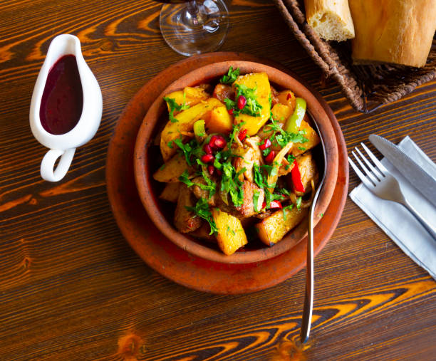 istock Traditional georgian Ojakhuri with pomegranate in earthenware ketsi pan 1322979740