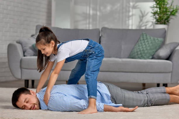 istock happy little child daughter doing massage to father 1322980298