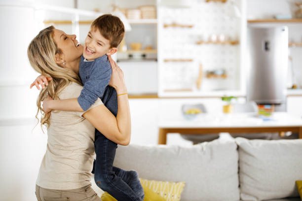 istock Happy boy having fun with his single mother at home. 1322980918