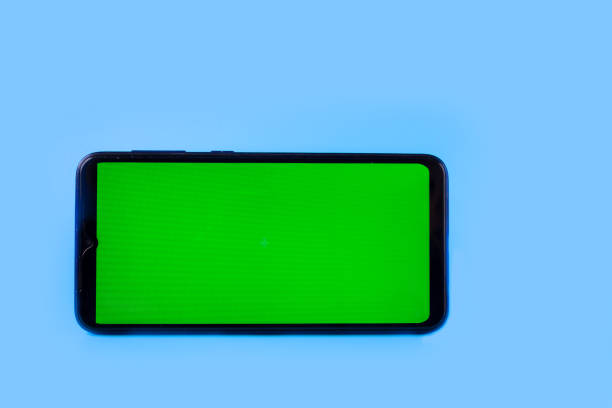 istock Smartphone in a horizontal position with a green screen on a blue background. Chroma key. Mock up 1322982156