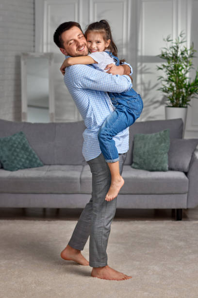 istock smiling father hugging his cute little child daughter. 1322982196