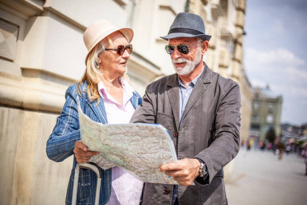 istock Senior tourists looking at a city map. 1322982469