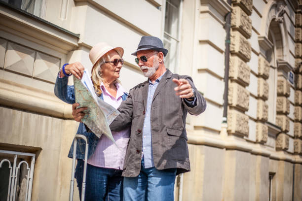 istock Senior tourists looking at a city map. 1322982500