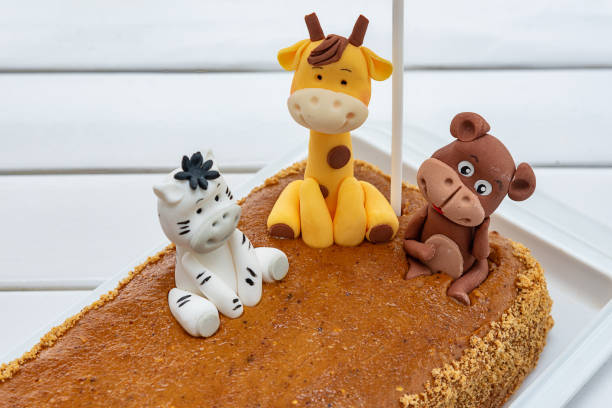 istock Children's birthday cake with giraffe, monkey and zebra 1322984515