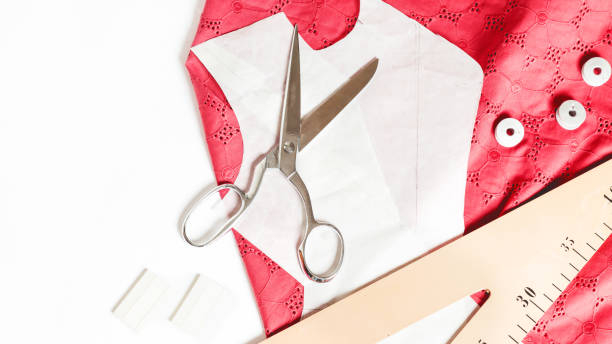 istock Pattern of clothing. Pattern of clothes on a white background. Sew clothes with a pattern. Tailoring scissors for creating fashionable clothes. Tailoring and sewing clothes. View from above 1322988168