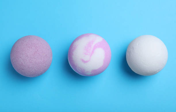 istock Colorful bath bombs on light blue background, flat lay 1322989160