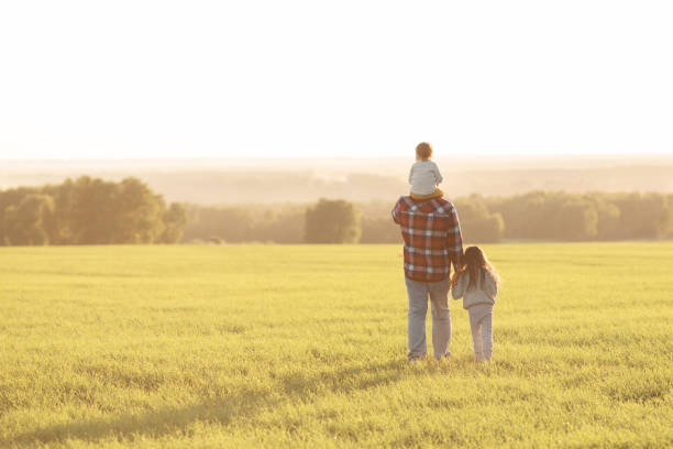 istock father with young daughters on the sunset 1322989171