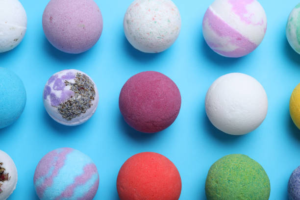 istock Colorful bath bombs on light blue background, flat lay 1322989187